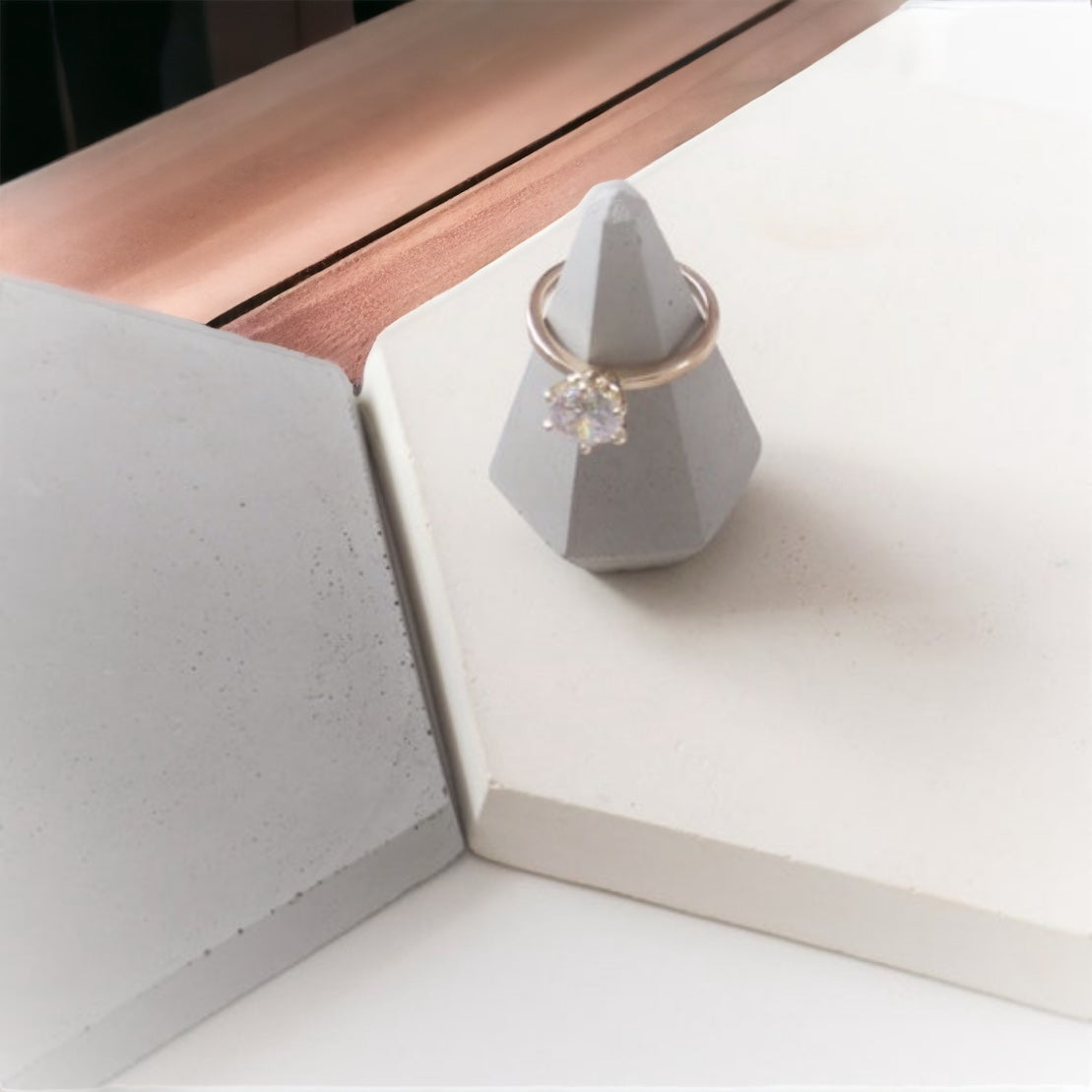 Gray ring holder in the shape of a diamond