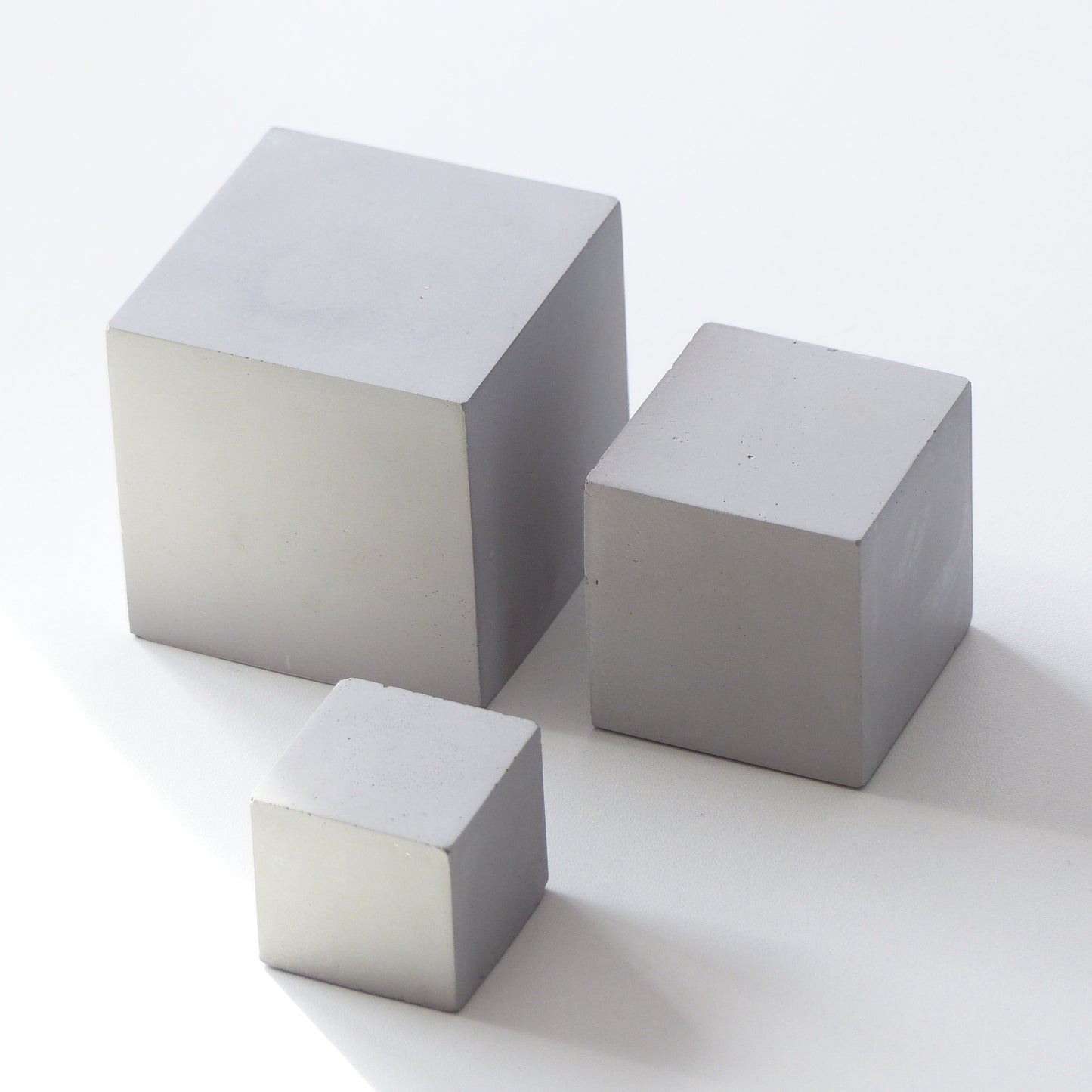 Three gray concrete cubes