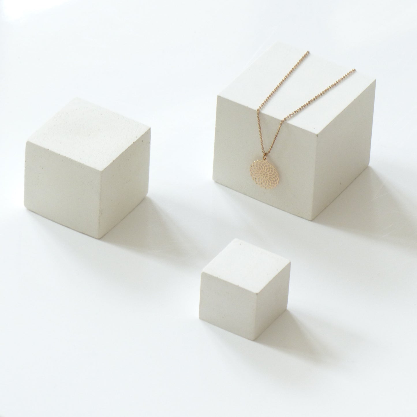 Three white concrete cubes